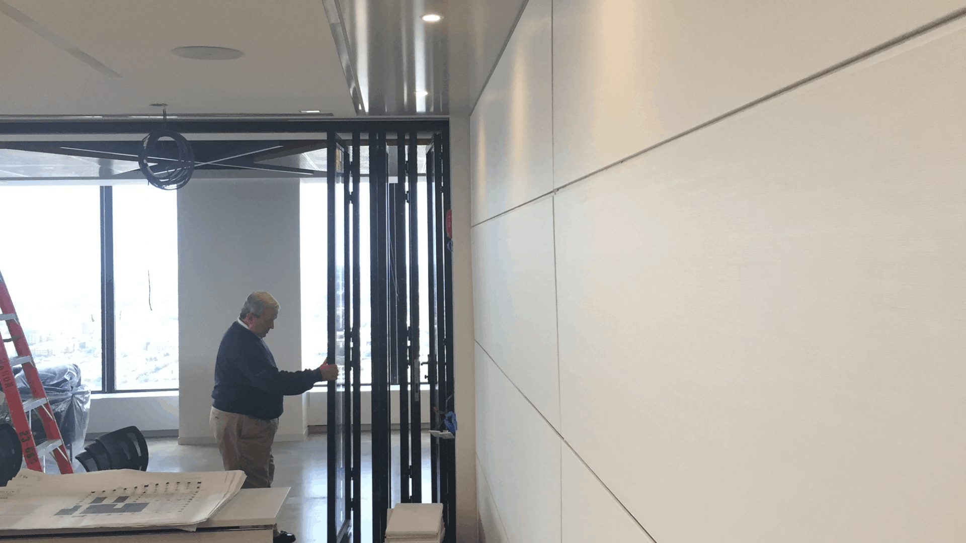 man-performing-operable-wall-servicing